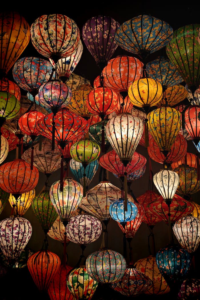 A vibrant collection of traditional Asian lanterns illuminated at night in Hong Kong, capturing a festive atmosphere.